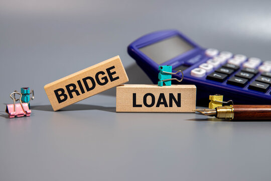 Business concept. Text bridge loan writing on paper and pen.