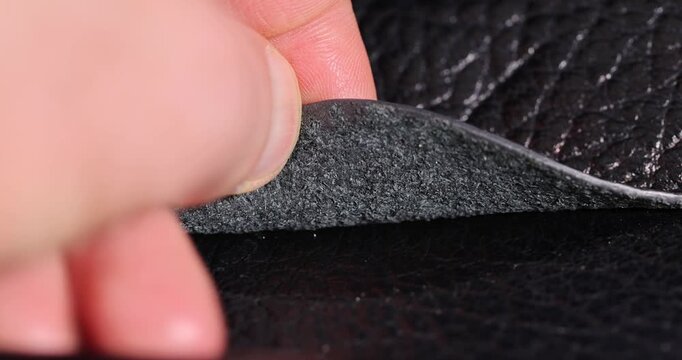 details of a natural black leather bag after prolonged use, details and pieces of natural leather used for the production of items, blank