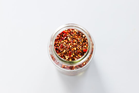 chilli flakes in glass pantry jar, top down close up