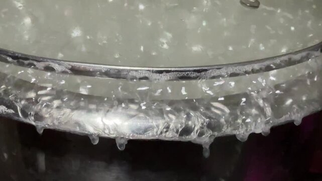Extreme Close-Up of Boiling Starch Foam Overflowing a Cooking Pot