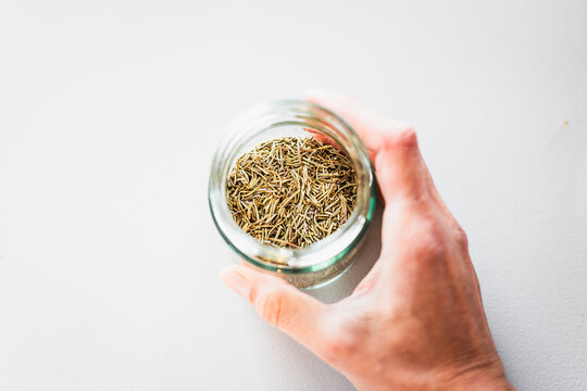 dried rosemary in glass pantry jar, top down close up