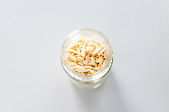 slivered almonds in glass pantry jar; top down close up