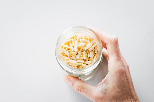 slivered almonds in glass pantry jar, top down close up