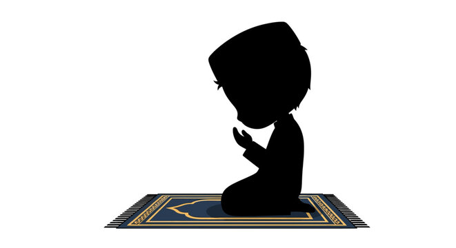 Black silhouette of a young Muslim boy wearing a skullcap sitting on a patterned prayer rug in a position of supplication isolated on a plain white background for religious concepts.