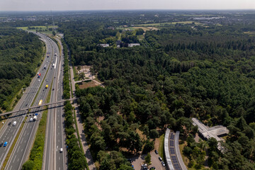 Obraz premium Aerial of A28 freeway in Dutch moorland sand landscape of Leusden near Amersfoort. Traffic and artery interstate seen from above.