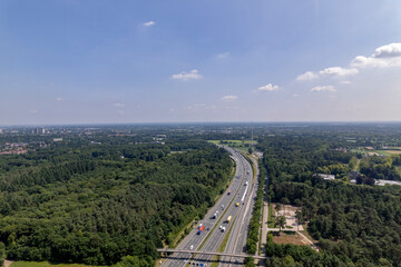 Obraz premium Aerial of A28 freeway in Dutch moorland sand landscape of Leusden near Amersfoort. Traffic and artery interstate seen from above.