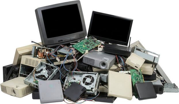 A pile of discarded electronic devices including computer monitors circuit boards projectors and computer components symbolizing obsolescence electronic waste ewaste recycling