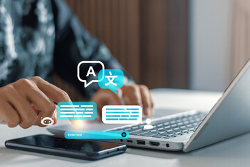 Businessman using laptop and smartphone with digital language translation interface icons. Language translation, global communication, multi-lingual localization, cultural connectivity, AI chatbot © iqbal