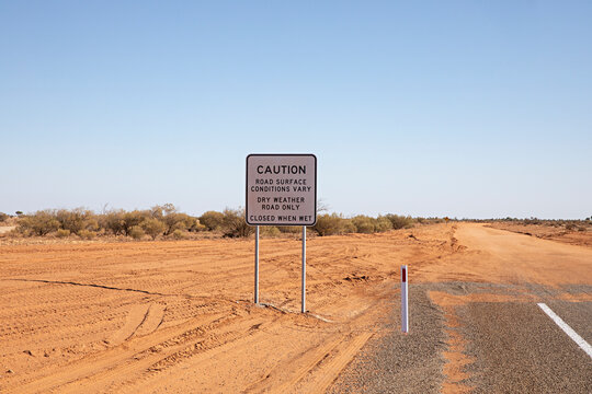 End of the road. Where the paved road ends and red dirt road begins in outback New South Wales, Australia