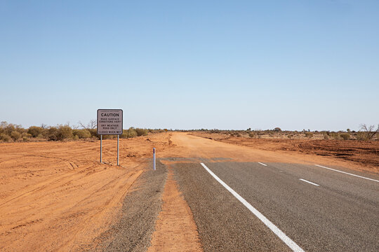 End of the road. Where the paved road ends and red dirt road begins in outback New South Wales, Australia