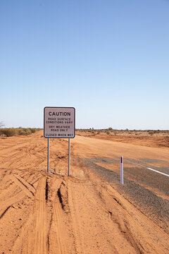 End of the road. Where the paved road ends and red dirt road begins in outback New South Wales, Australia
