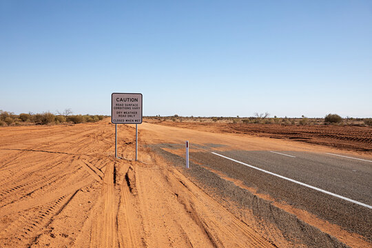 End of the road. Where the paved road ends and red dirt road begins in outback New South Wales, Australia