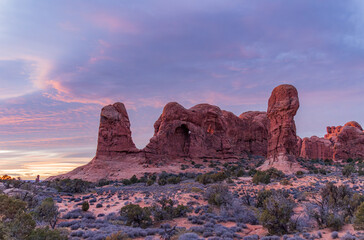 Sunset illuminates the Turret Arch formation in a desert landscape. © Kit Leong