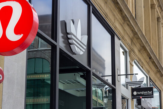 MONTREAL, CANADA, 25 December 2025 : Storefront logos adidas lululemon sunglass hut urban architecture shopping district