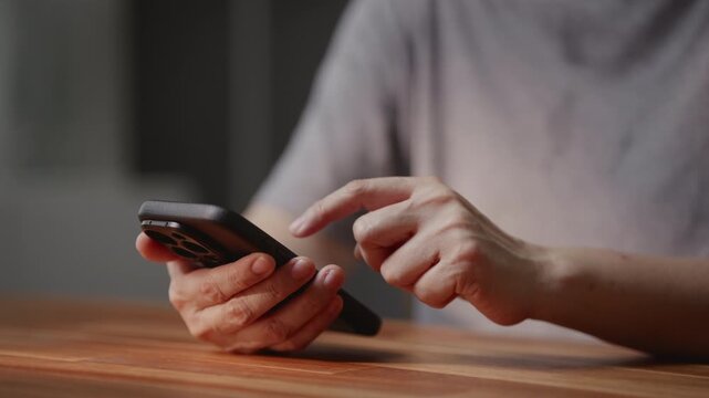 Smartphone user using payment banking app, typing chat with artificial intelligence assistant technology, searching information on social media network, closeup view of modern lifestyle.
