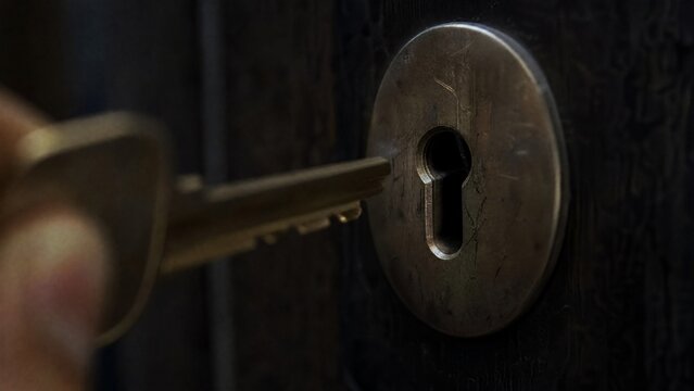 misaligned. A metal key slightly misaligned with a door lock's keyhole in dim light. product launch decks, UI/UX mockups, designed for data visualization dashboards and holographic UIs.