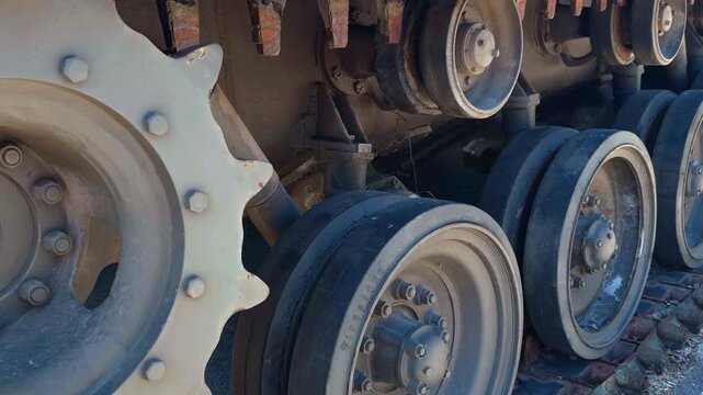 VIENNA, AUSTRIA - MAY 4, 2026: Close up view of an M60 Patton tank drive sprocket gear, rubber tired road wheels, and track links at the Museum of Military History on a sunny day.