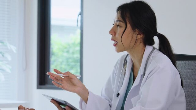 Doctor listens to an elderly patient during a senior healthcare hospital check-up and interview for a thorough medical consultation visit, discussing a symptom to decide the best treatment