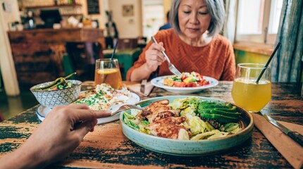 Fototapeta premium Older woman dining at a cafe with healthy food