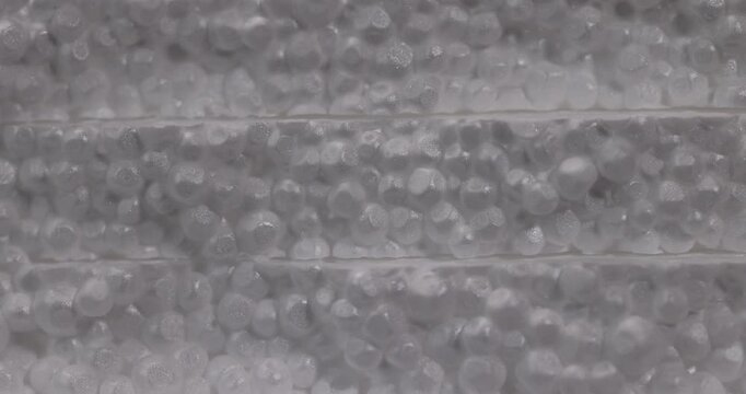 White foam with embossed layers, this stepped foam consists of round granules and forms a wave-like surface structure.