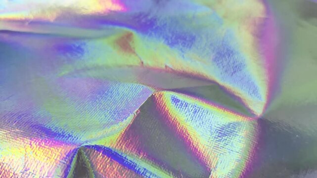 Abstract Holographic Foil Background with Vibrant Iridescent Colors and Light Reflections.