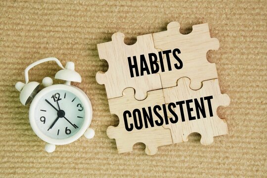 Wooden puzzle with word Habits and Consistent. eliminate the need for sheer willpower. By linking a new behavior to an already established, consistent routine 