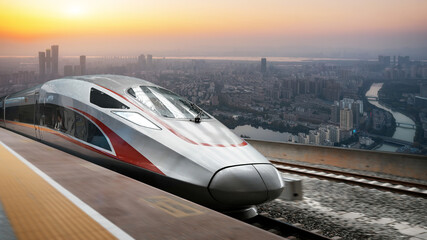 Fototapeta premium High speed bullet train stopped at urban railway station at sunset
