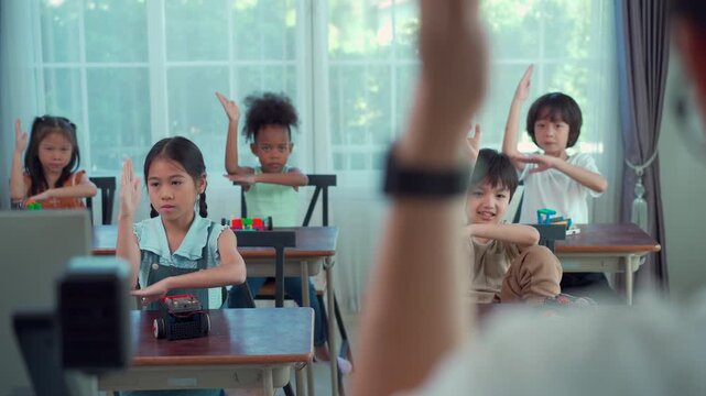 Happy school children participating in interactive STEM lesson