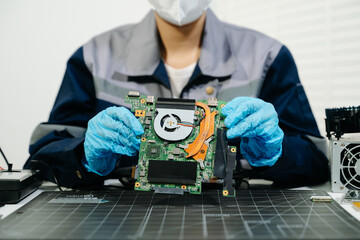Obraz premium Electronics Technician Soldering Laptop Motherboard Circuit in Workshop