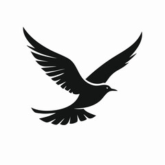 Fototapeta premium Silhouette of a black bird in flight with wings spread wide against a clean white background