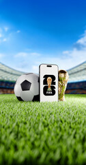 Fototapeta premium Mobile phone with 2026 FIFA World Cup Logo on Green Grass of a Modern Football Stadium with Trophy and Ball. Vertical Format.