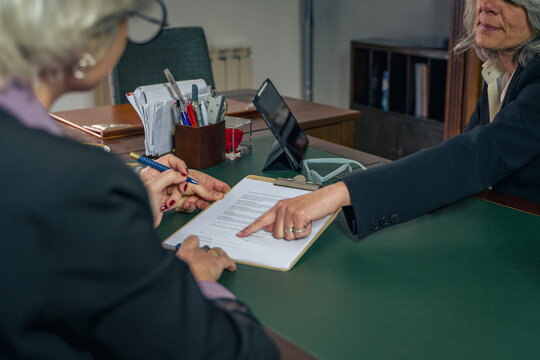 Financial advisor explaining contract terms to clients during office meeting