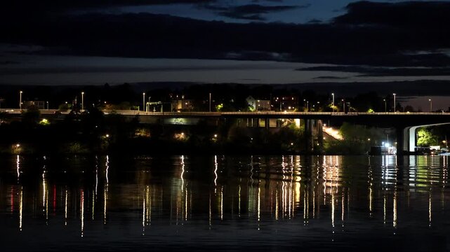 Stockholm, Sweden A night view of Lake Malaren with reflections of the landmark E4 and Essingeleden bridge.
