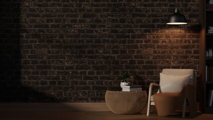 Fototapeta premium Hanging lamp shining over white armchair and woven table beside bookshelf in dim lit brick wall room