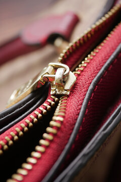 Close view of a broken zipper on a handbag