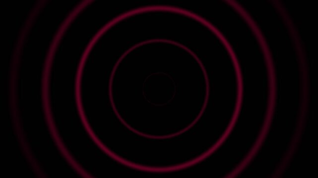 Concentric red circles radiating outward against a deep black background