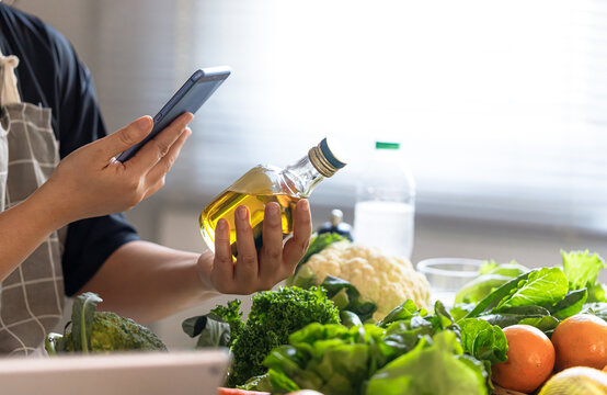 Middle Aged Asian Man Checking Olive Oil for Healthy Aging Diet