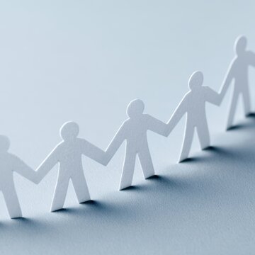 Paper people holding hands in unity circle, teamwork and global business connection symbolism