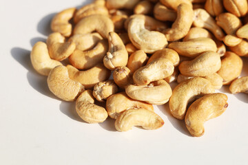 Fototapeta premium Roasted cashew nuts on a white background.