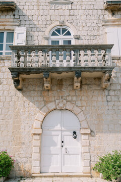 Decorative stone exterior with balcony. Charming limestone structure featuring arched entrance