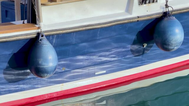 Blue Yacht Hull with Round Fenders in Cassis Harbor France