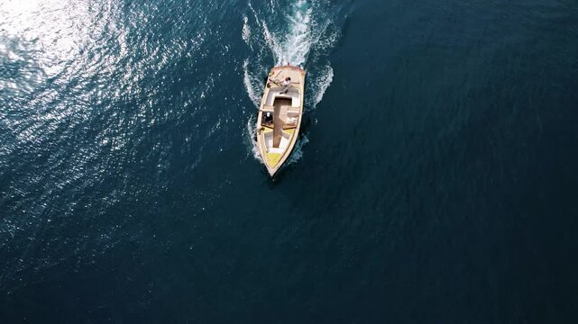 Vessel nears islet church. Maritime craft progresses towards coastal chapel situated on tiny island in scenic bay