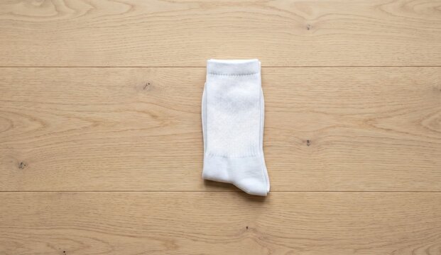Blank folded white cotton socks mockup flat lay on wooden floor