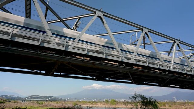 Shinkansen crossing the Fuji with Mount Fuji in the background in Shizuoka JAPAN APR 20 2026
