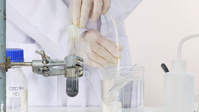 Scientist Setting Up Chemical Reaction with Concentrated Hydrochloric Acid