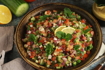 Fototapeta premium A bowl of Shirazi salad, traditional dish of Iran, in rustic style 