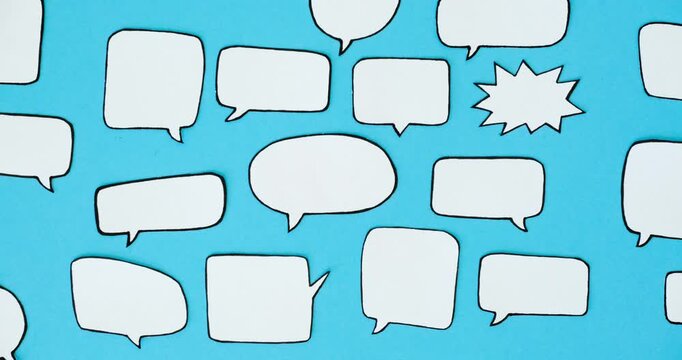 Pattern of black and white speech bubbles on a blue background. Communication and social connections concept. Looped 4K stop motion animation