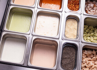 Fototapeta premium Fresh Salad Bar Ingredients and Toppings in Stainless Steel Food Containers