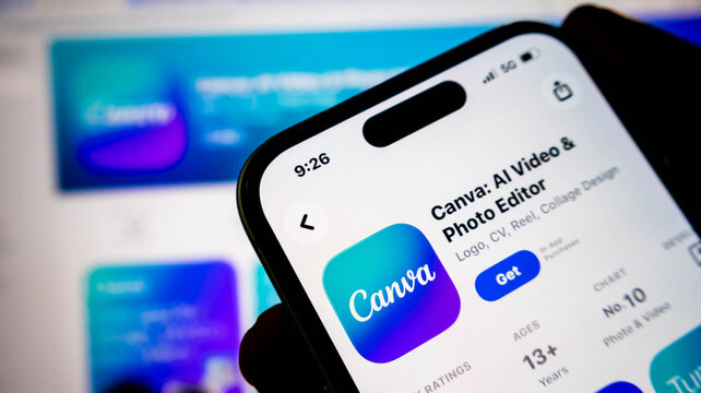 Closeup of a smartphone screen displaying the canva app page in the apple app store, showcasing its ai video and photo editing features