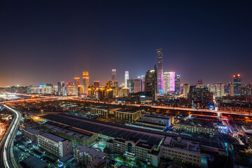 Obraz premium After a snowfall in China, Beijing's CBD, including the China Zun building, boasts a vibrant cityscape and a panoramic view of the bustling central business district at night.